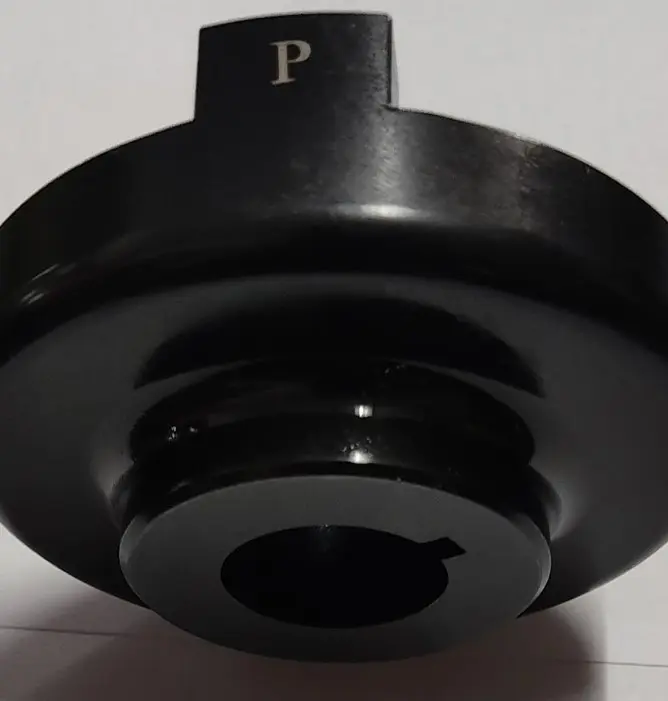 A black metal spacer and coupler component with a central circular opening and a 'P' marking, displayed on a white background.
